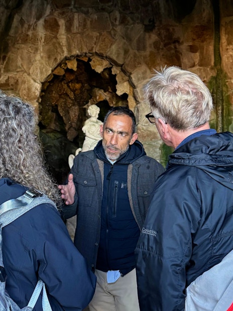 Tourists with guide inside Quinta da Regaleira's grotto, Sintra, Portugal.