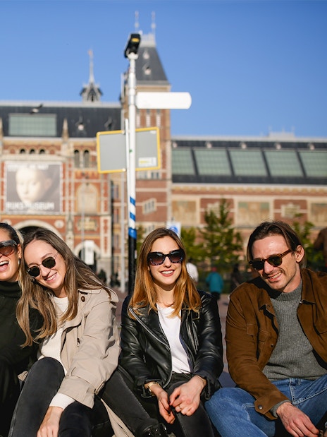 Group enjoying a professional photoshoot in front of the Rijksmuseum, Amsterdam.