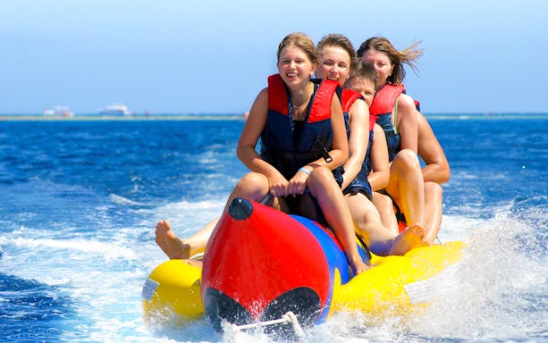 Group enjoying a banana boat ride in Orange Bay, Egypt.