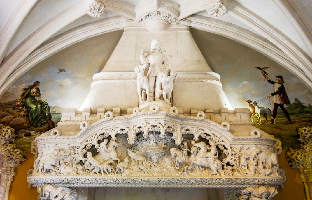 Quinta Da Regaleira hunter room with ornate wooden ceiling and hunting-themed decor in Sintra, Portugal.