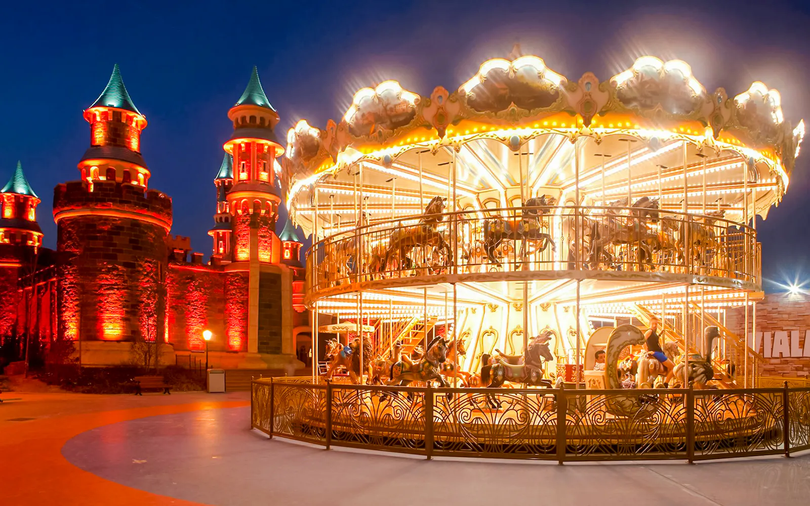 Guests enjoying a carousel ride at night in Vialand Theme Park, Istanbul.
