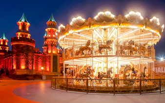 Guests enjoying a carousel ride at night in Vialand Theme Park, Istanbul.