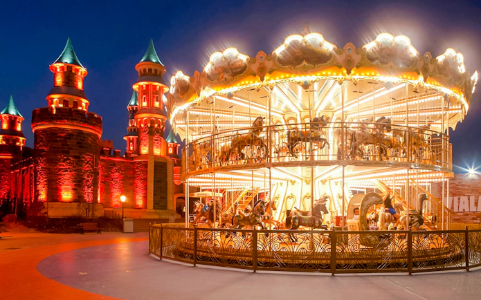 Guests enjoying a carousel ride at night in Vialand Theme Park, Istanbul.