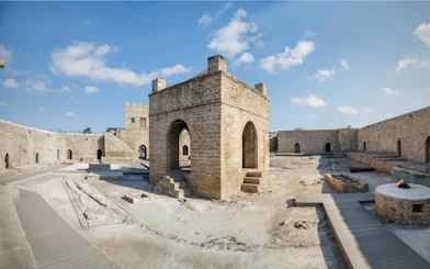 Baku Ateshgah Fire Temple courtyard with stone arches in Surakhani, Azerbaijan.