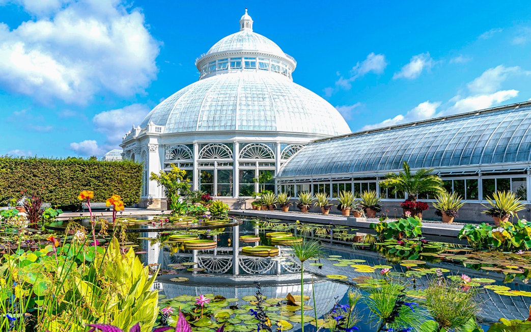 Enid A Haupt Conservatory at New York Botanical Garden with tropical plants and glass dome.
