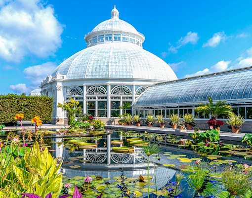 Enid A Haupt Conservatory at New York Botanical Garden with tropical plants and glass dome.