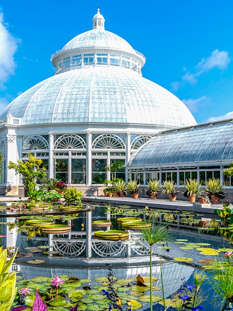 Enid A Haupt Conservatory at New York Botanical Garden with tropical plants and glass dome.