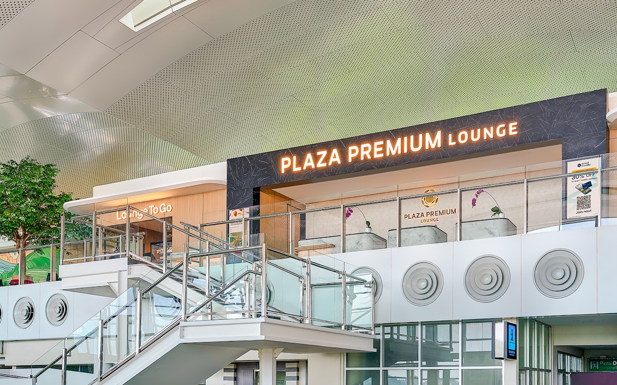Plaza Premium Lounge exterior with glass railings and signage.