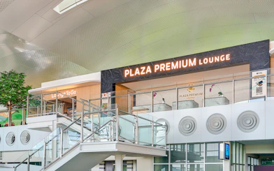 Plaza Premium Lounge exterior with glass railings and signage.