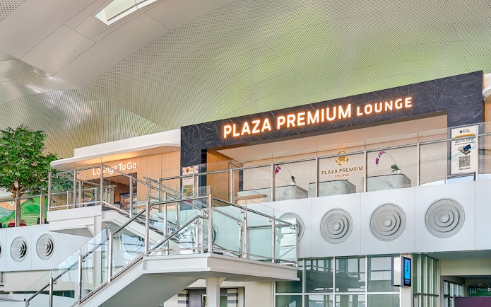 Plaza Premium Lounge exterior with glass railings and signage.