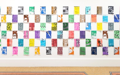 Colorful posters arranged in a grid at Stedelijk Museum's PostNoBills 5 exhibit.