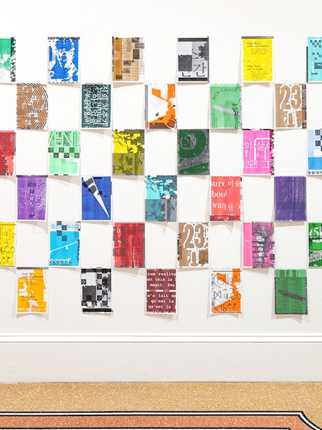 Colorful posters arranged in a grid at Stedelijk Museum's PostNoBills 5 exhibit.