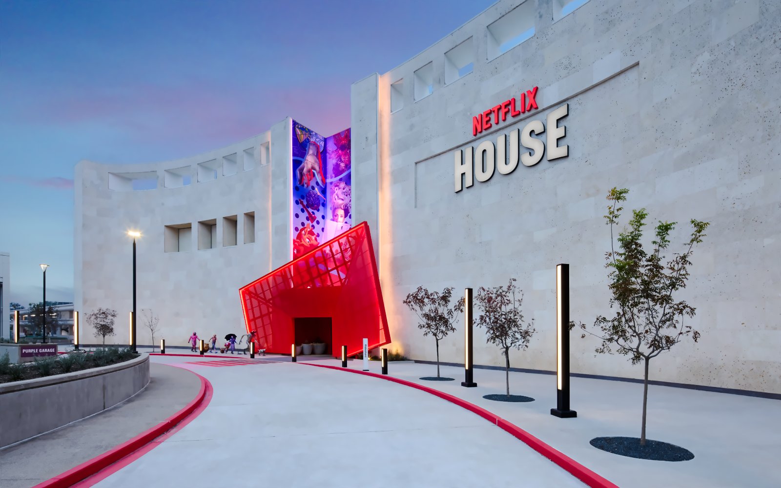 Netflix House entrance with vibrant red canopy and mural, Dallas.