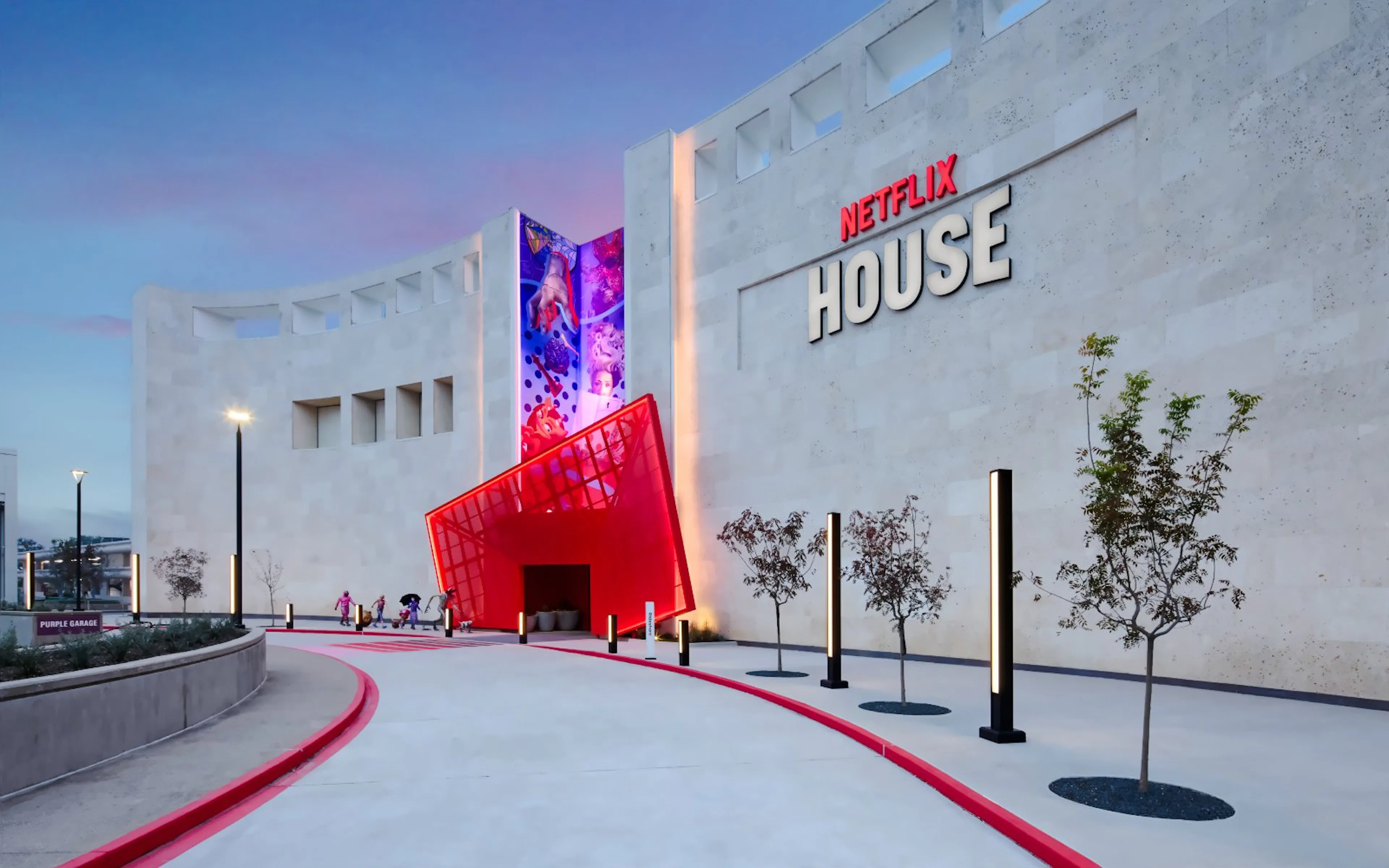 Netflix House entrance with vibrant red canopy and mural, Dallas.