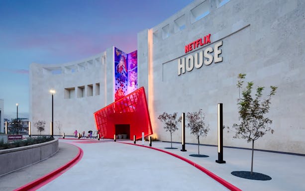 Netflix House entrance with vibrant red canopy and mural, Dallas.