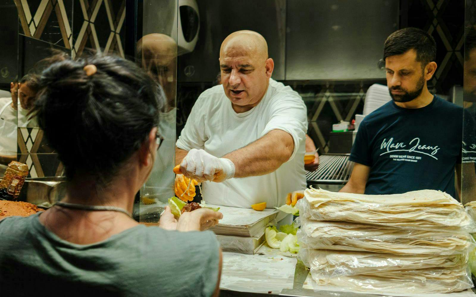 Chef preparing traditional Turkish kebab at a food stall in Istanbul.