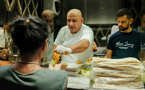 Chef preparing traditional Turkish kebab at a food stall in Istanbul.