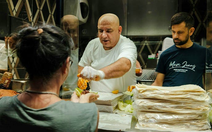 Chef preparing traditional Turkish kebab at a food stall in Istanbul.