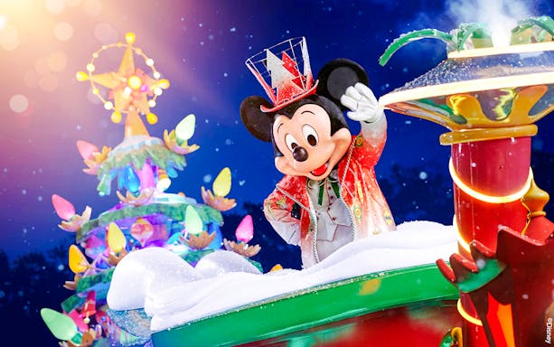 Mickey Mouse in festive attire at Disneyland Christmas 2025 parade.