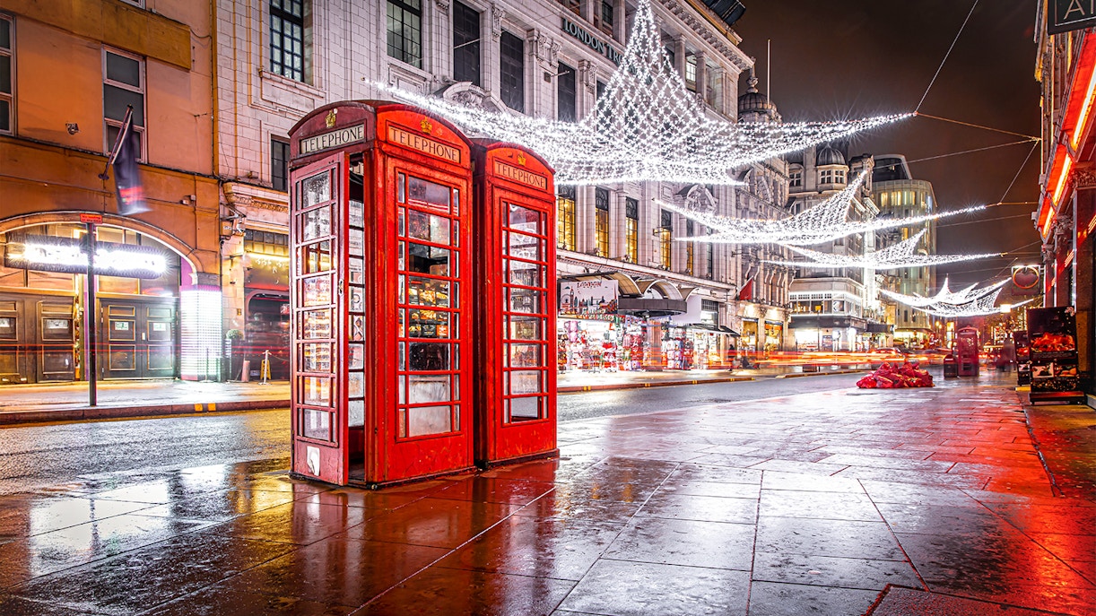 Leicester Square phone booth with Christmas lights and decorations in London.