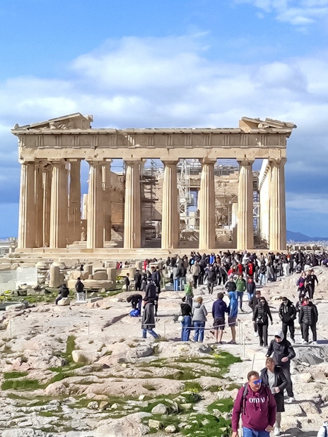 Crowds exploring the Parthenon on the Acropolis in Athens, Greece.