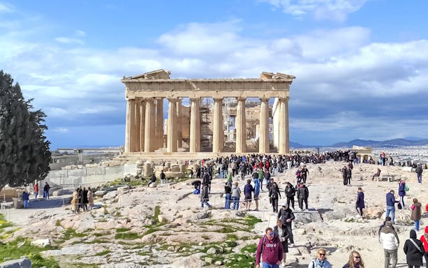 Crowds exploring the Parthenon on the Acropolis in Athens, Greece.