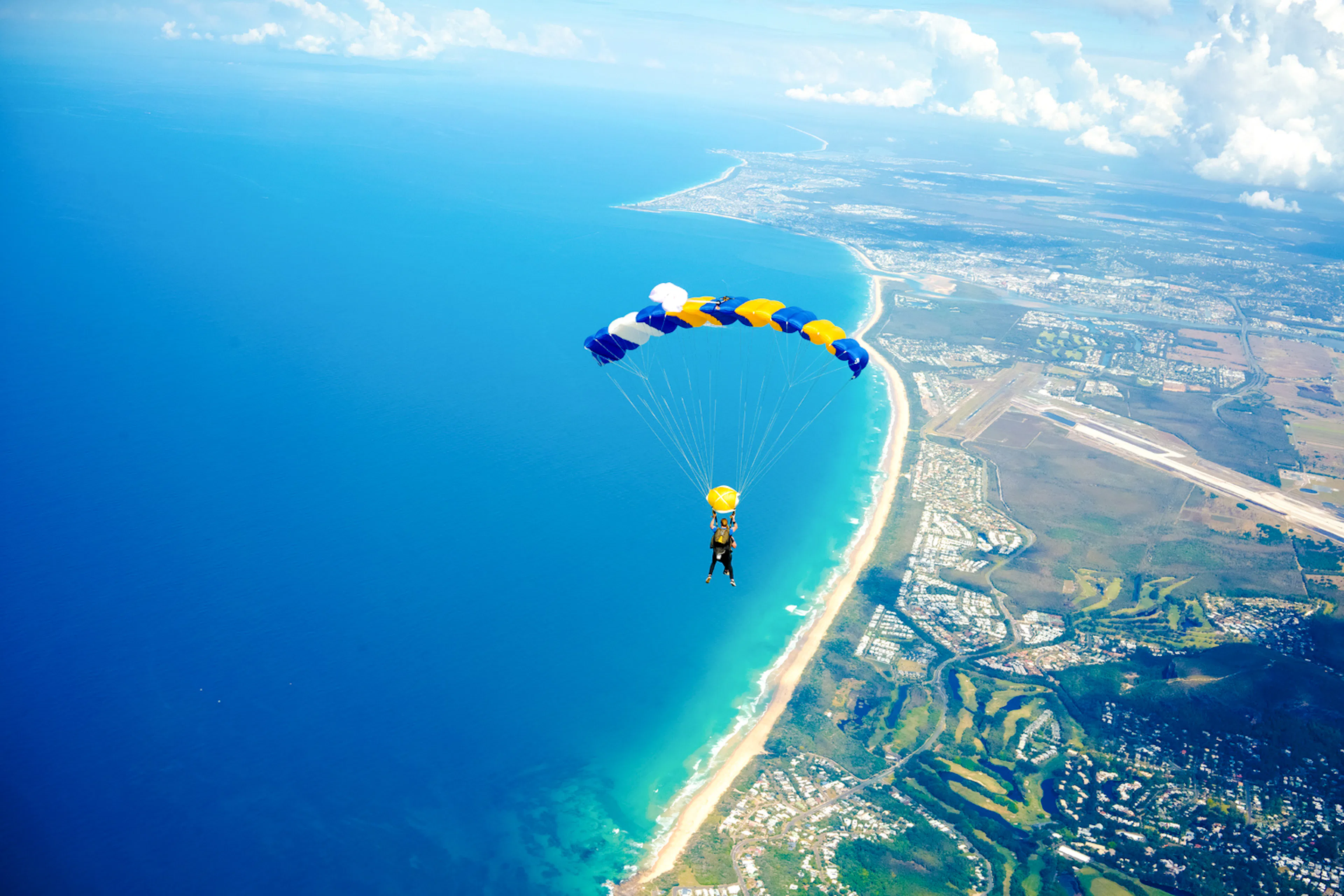 Tandem skydive over Noosa, Sunshine Coast with ocean and coastline view.
