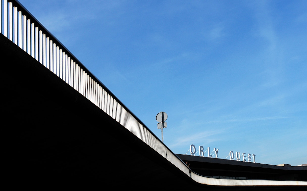 Orly Ouest terminal sign at Paris-Orly Airport under a clear blue sky.