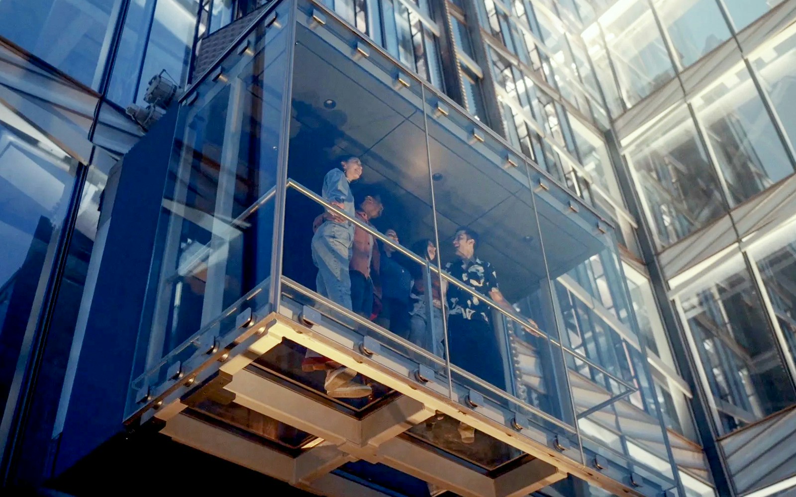 Glass elevator ascending at SUMMIT One Vanderbilt, New York City, offering panoramic views.