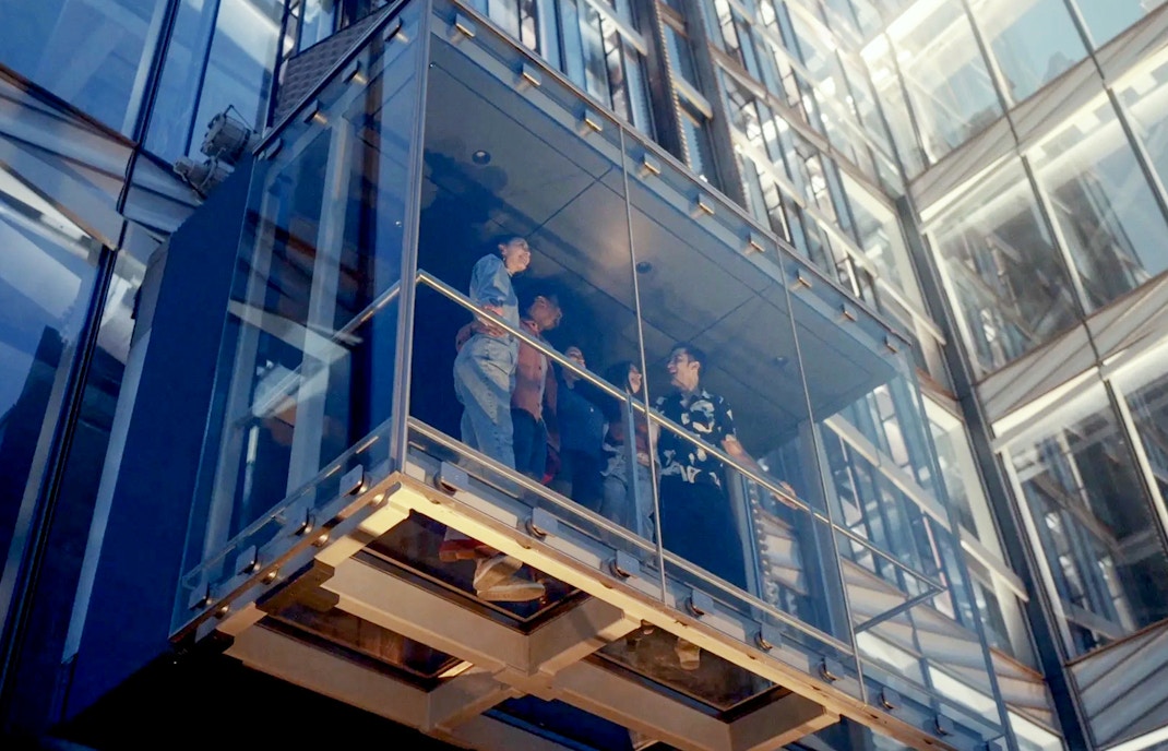 Glass elevator ascending at SUMMIT One Vanderbilt, New York City, offering panoramic views.