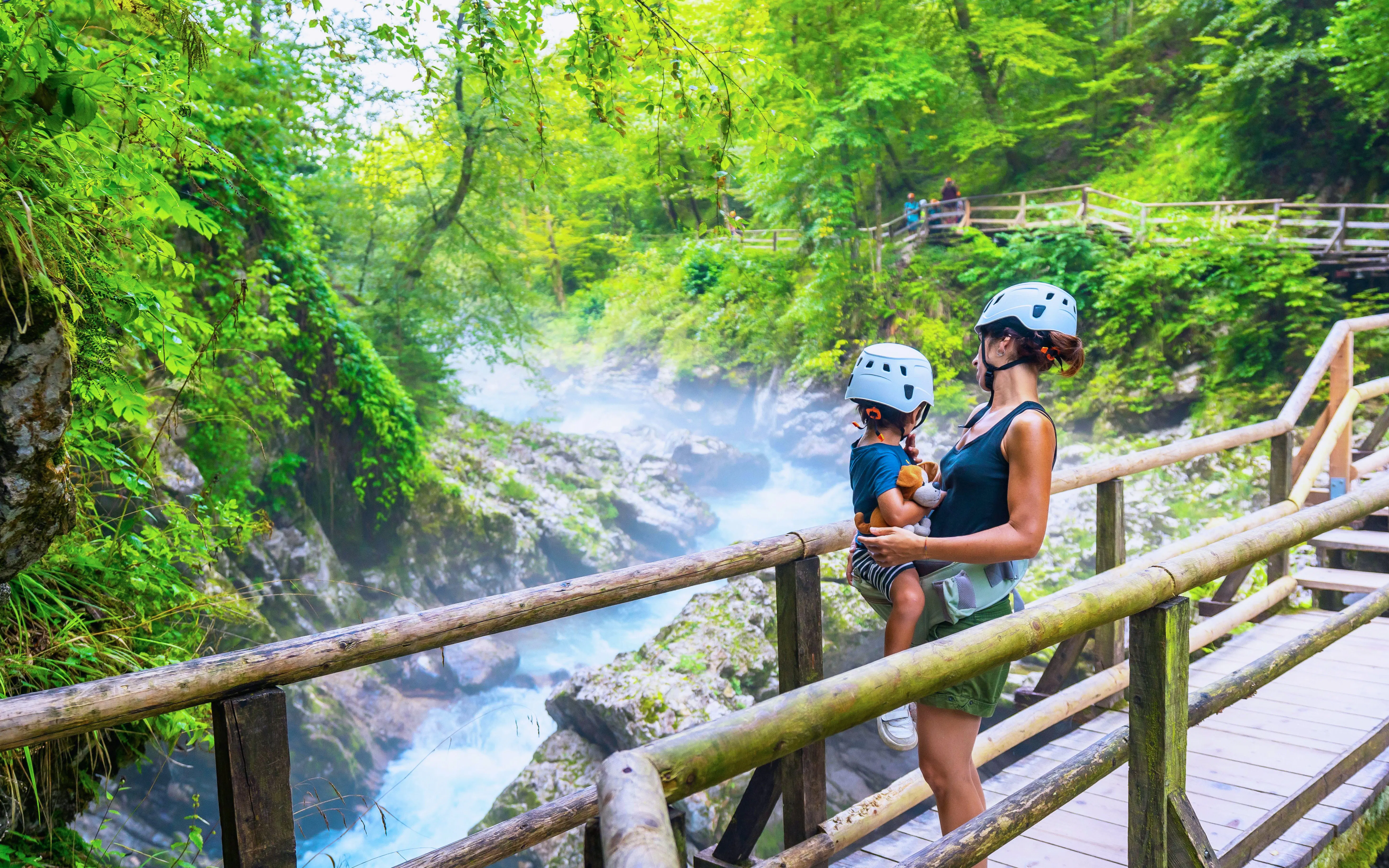 Mother and child on a wooden path in Vintgar Gorge, Bled, Slovenia.