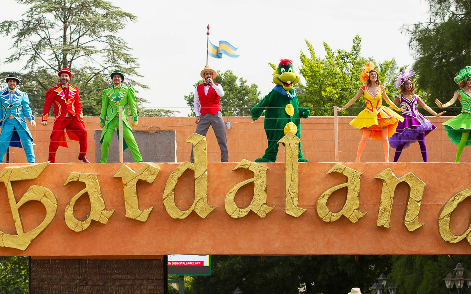 Performers in colorful costumes on stage at Gardaland's Good Morning Gardaland show.