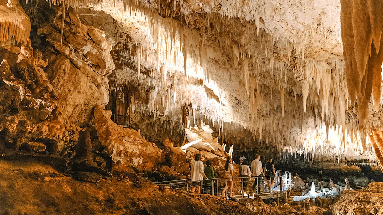 Visitors exploring stalactites in Jewel Cave, Margaret River guided tour.