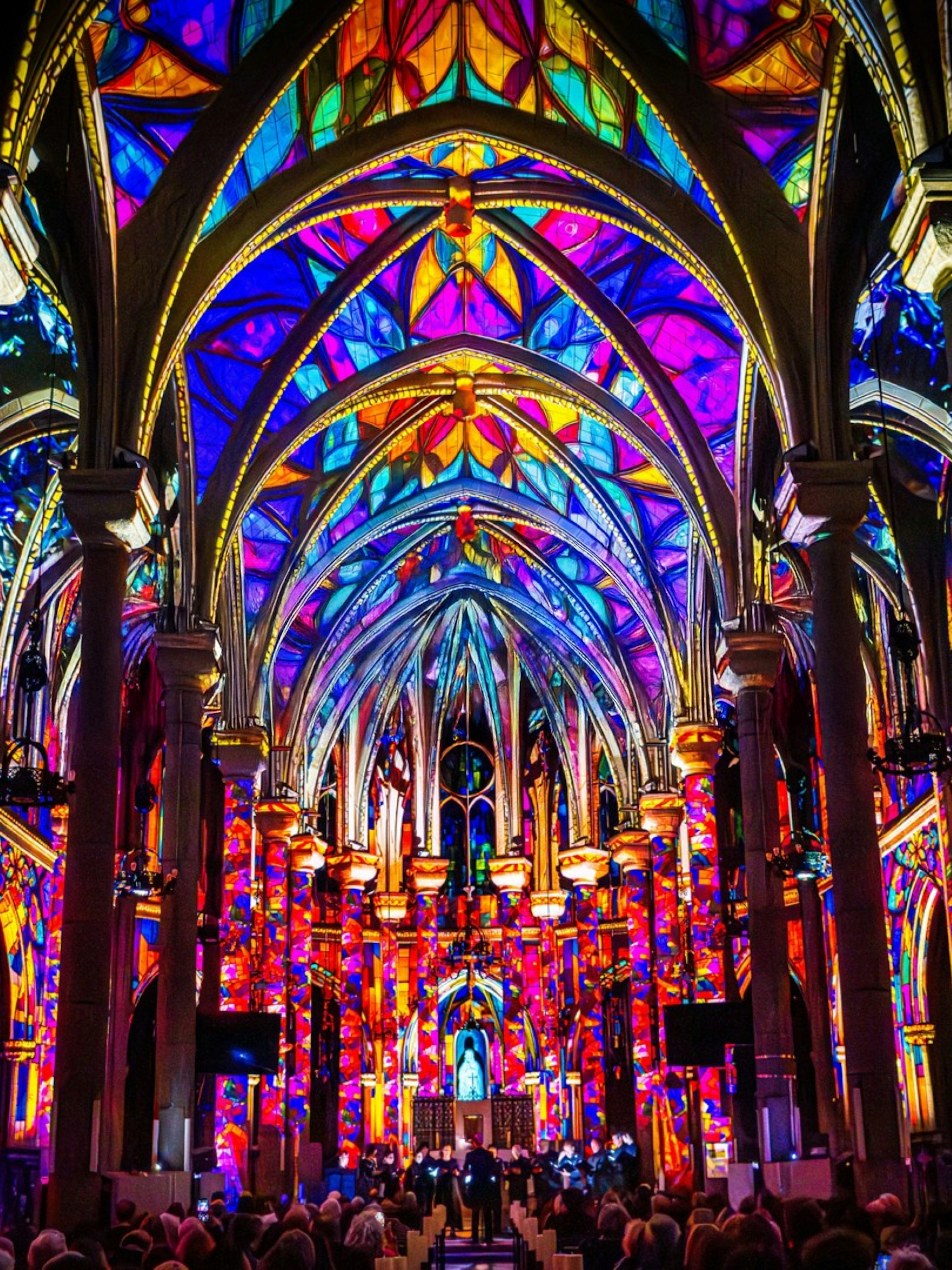 Westminster Cathedral interior illuminated with vibrant stained glass projections, London.