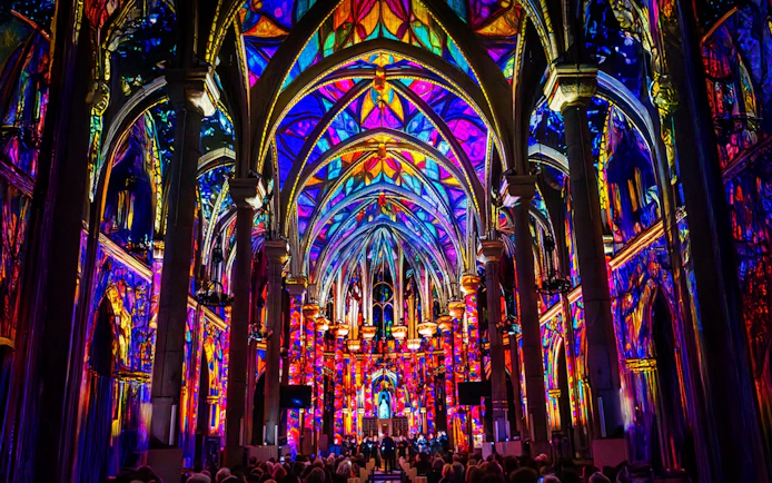 Westminster Cathedral interior illuminated with vibrant stained glass projections, London.