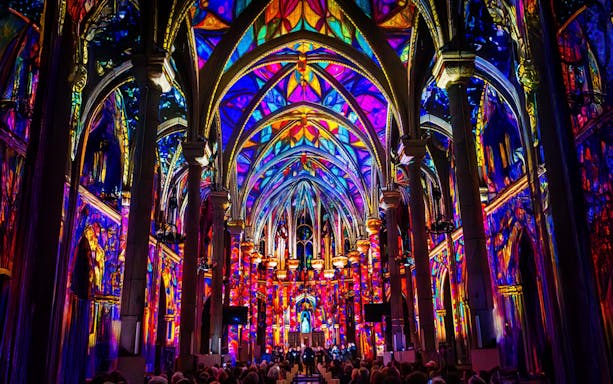 Westminster Cathedral interior illuminated with vibrant stained glass projections, London.
