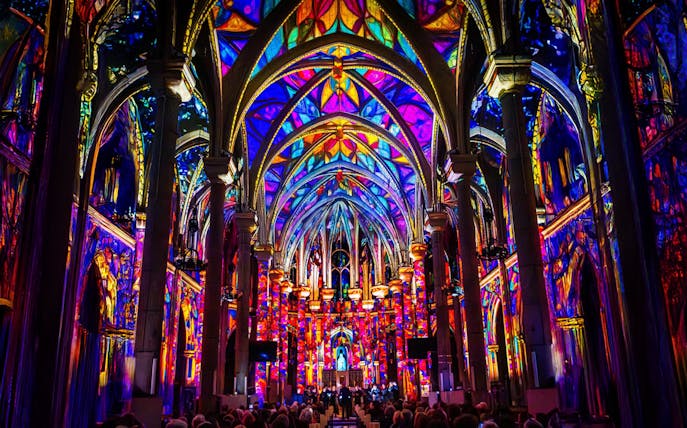 Westminster Cathedral interior illuminated with vibrant stained glass projections, London.