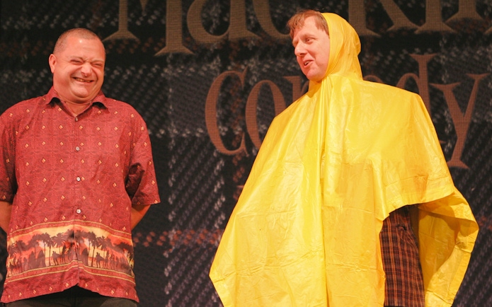 Two performers on stage during The Mac King Comedy Magic Show in Vegas.