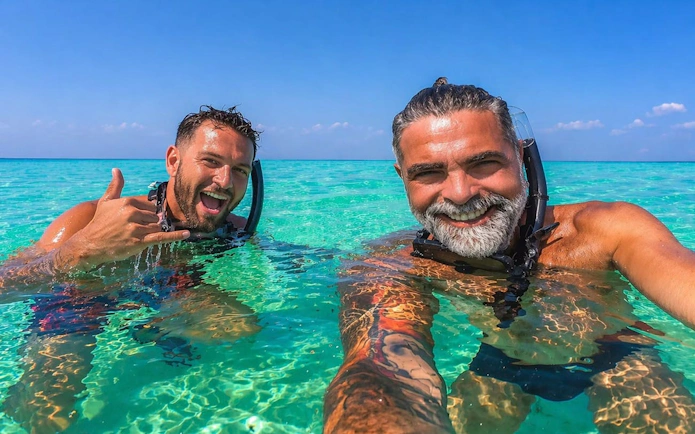 Two people snorkeling in clear waters during Phi Phi and Bamboo Island tour from Phuket.