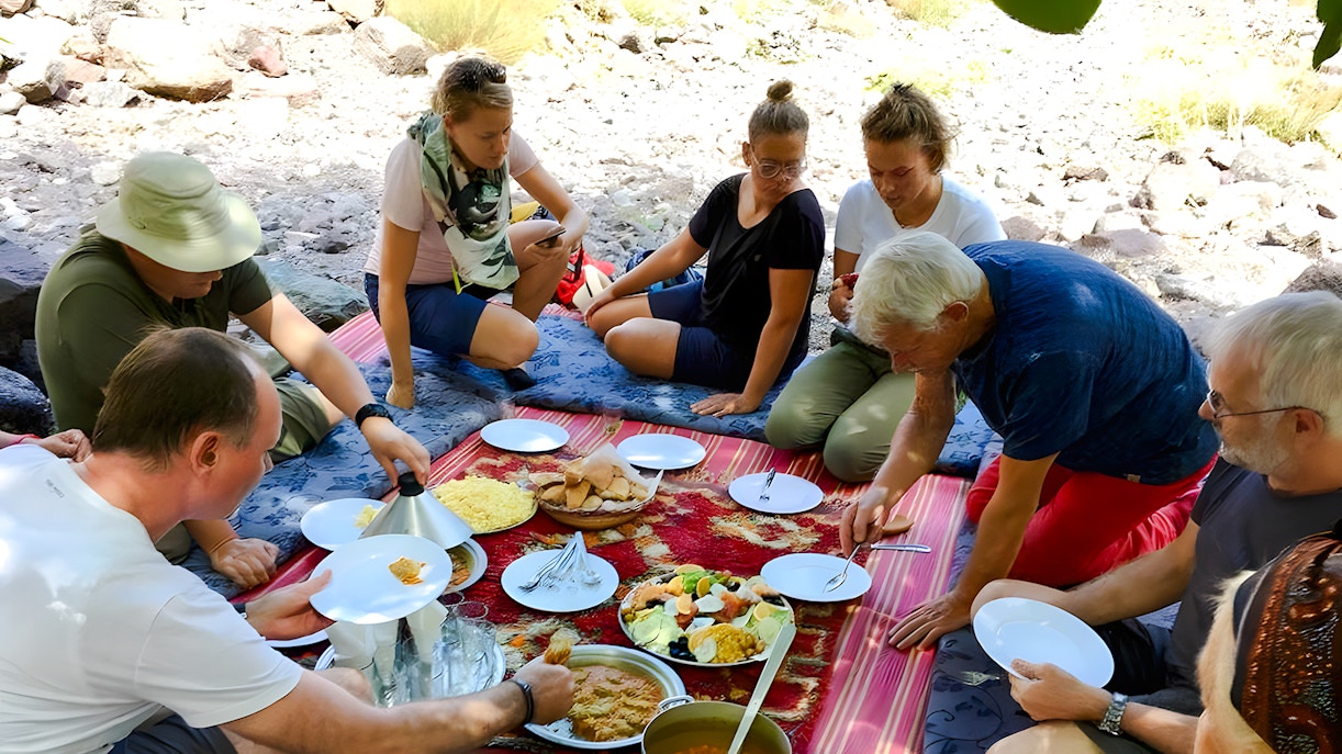 People enjoying a traditional Moroccan meal in Agafay Desert, Marrakech.