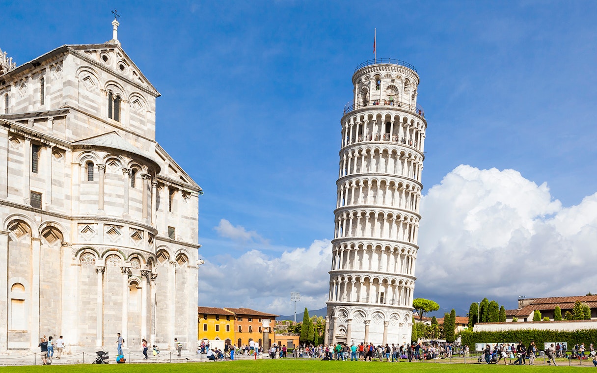 Pisa Cathedral and Leaning Tower with tourists, Pisa, Italy.
