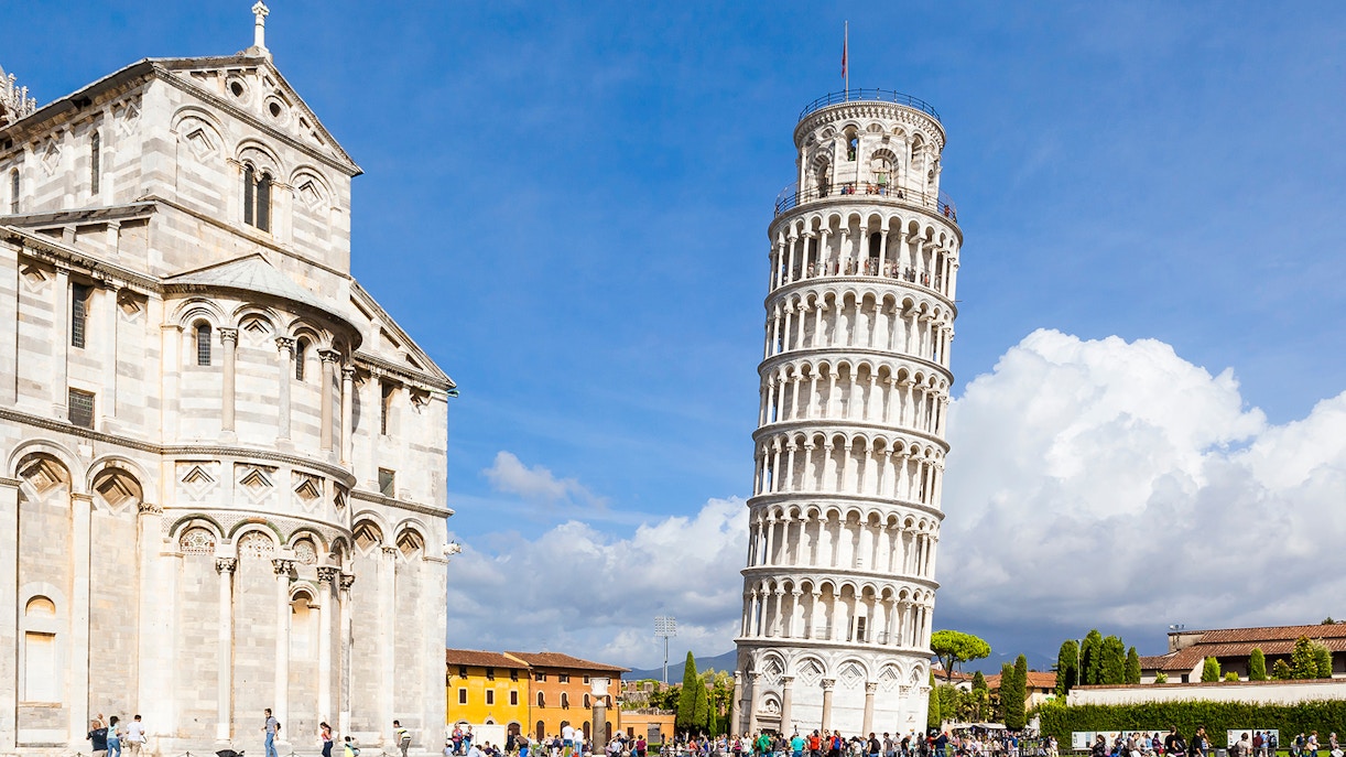 Pisa Cathedral and Leaning Tower with tourists, Pisa, Italy.