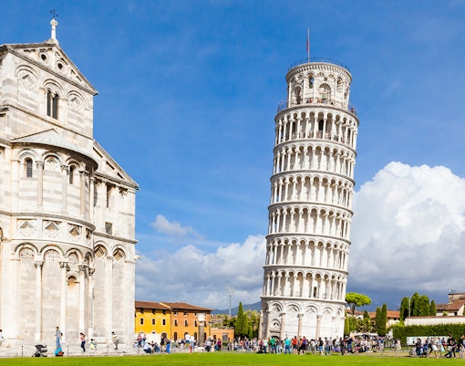 Pisa Cathedral and Leaning Tower with tourists, Pisa, Italy.
