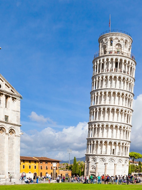Pisa Cathedral and Leaning Tower with tourists, Pisa, Italy.