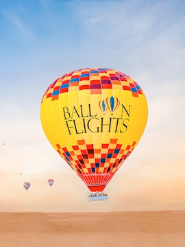 Hot air balloon over desert landscape, limited time deal.