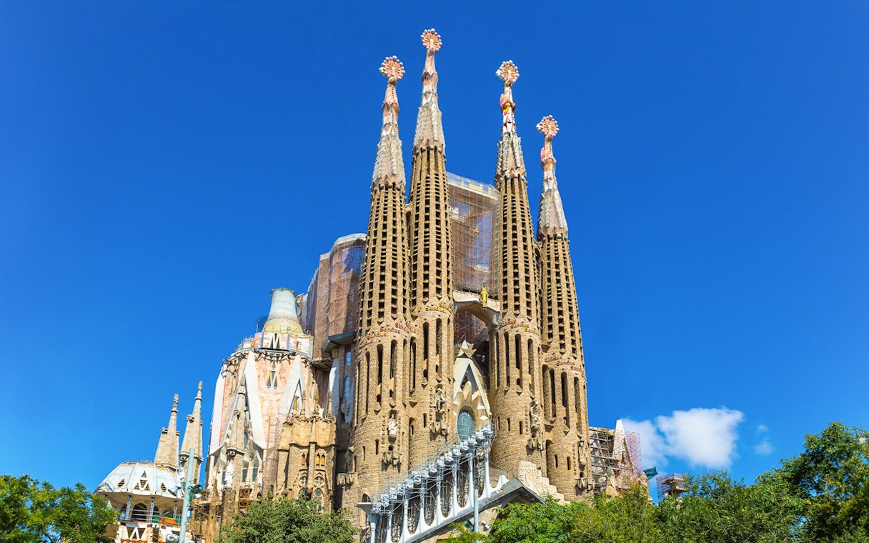 Sagrada Familia basilica towers against a clear blue sky in Barcelona.