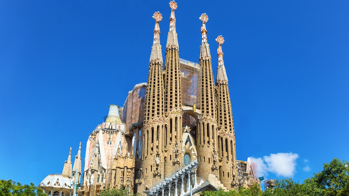 Sagrada Familia basilica towers against a clear blue sky in Barcelona.