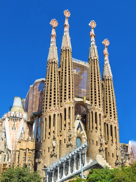 Sagrada Familia basilica towers against a clear blue sky in Barcelona.