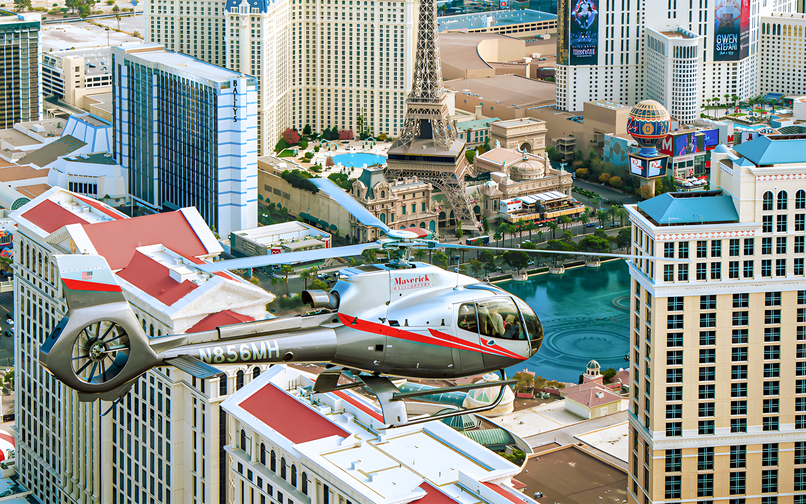 Maverick Helicopter flying over the Las Vegas Strip with city landmarks below.