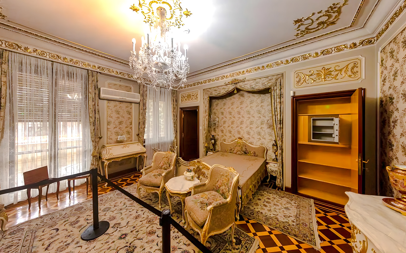 Interior of Ceaușescu Mansion bedroom with ornate decor and chandelier, Bucharest.